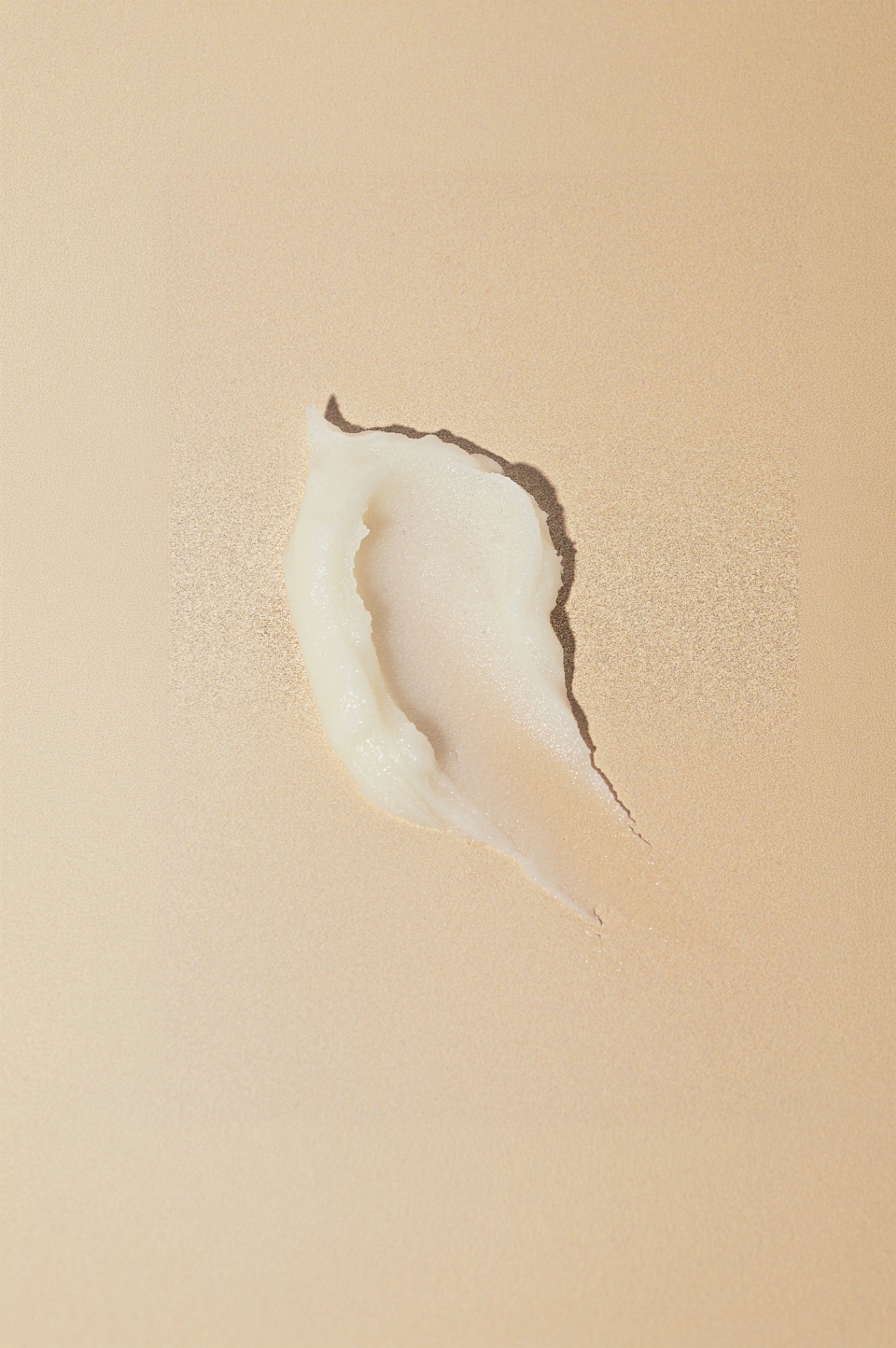 Swirl of Buttermilk Balm on a warm beige surface